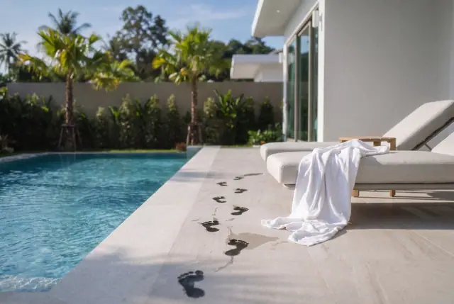 Wet footprints beside the pool