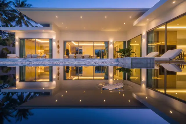 The villa reflected in its pool at night