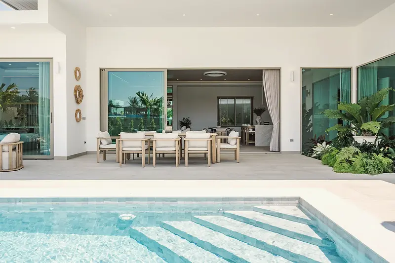 The covered terrace opening onto the pool